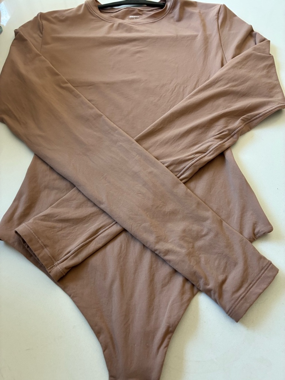 SKIMS Long Sleeve Thong Bodysuit in Mauve Brown